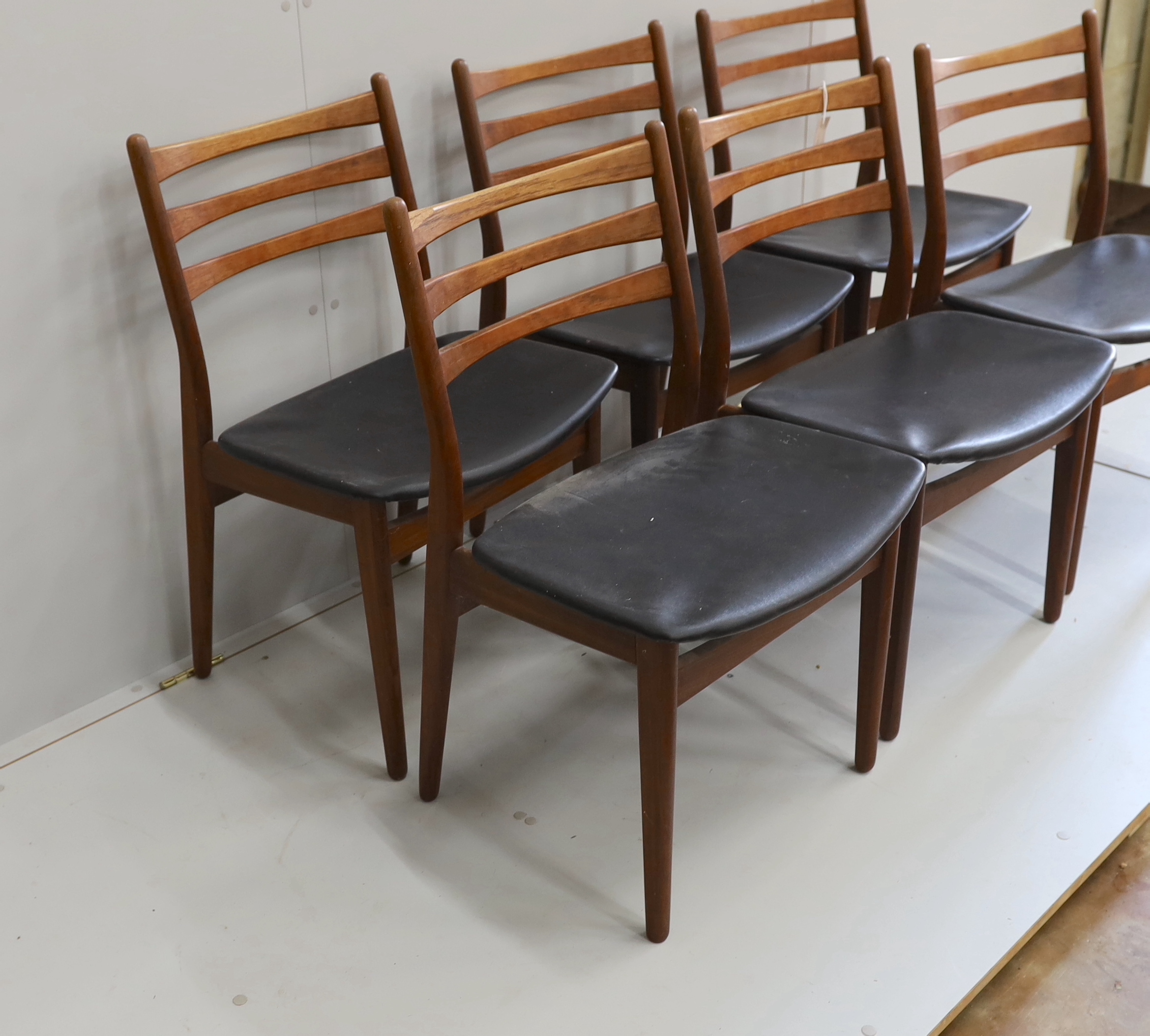 A set of six mid century, Danish design, teak and black leatherette dining chairs, width 50cm, depth 40cm, height 80cm